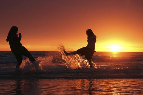 two people enjoying a beach sunrise